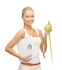 Image showing sporty woman with scale, apple and measuring tape