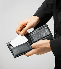 Image showing man in suit holding credit card