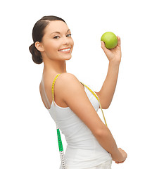Image showing sporty woman with apple and measuring tape