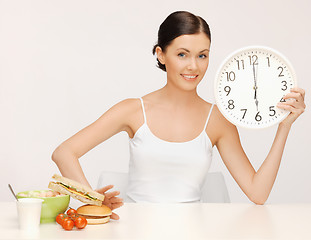 Image showing woman with big clock