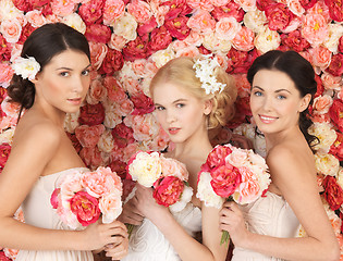 Image showing three women with background full of roses