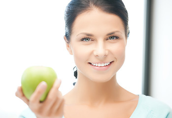 Image showing woman in the kitchen with an apple