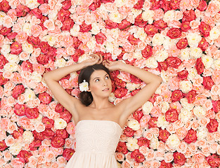 Image showing young woman with background full of roses