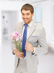 Image showing handsome man with flowers in hand