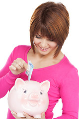 Image showing lovely woman with piggy bank and money