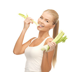 Image showing woman biting piece of celery or green salad