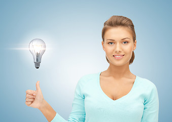 Image showing woman with light bulb showing thumbs up