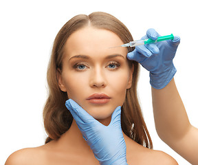 Image showing woman face and beautician hands