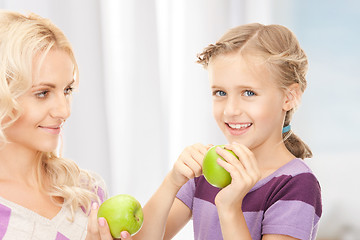 Image showing mother and little girl with green apple