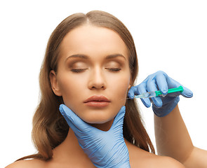 Image showing woman face and beautician hands