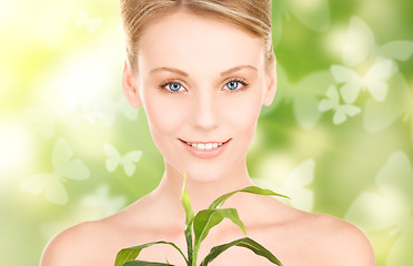 Image showing woman with sprout and butterflies