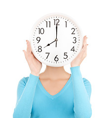 Image showing businesswoman with clock over her face