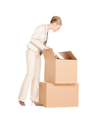 Image showing businesswoman unpacking big boxes