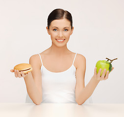 Image showing woman with hamburger and apple