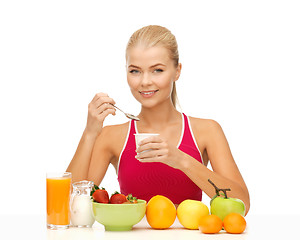 Image showing young woman eating healthy breakfast