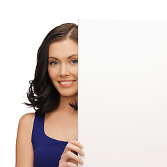 Image showing lovely woman in blue dress with blank board