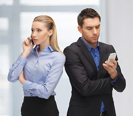 Image showing man and woman with cell phones