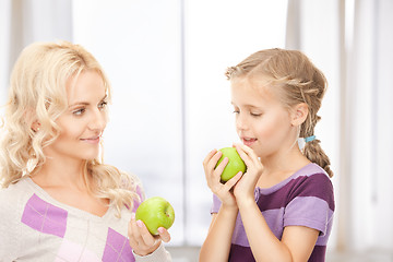 Image showing mother and little girl with green apple