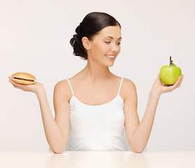 Image showing woman with hamburger and apple