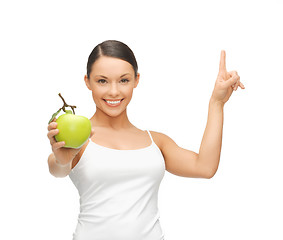 Image showing woman with green apple pointing her finger up