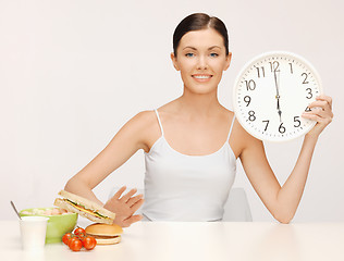 Image showing woman with big clock