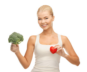 Image showing woman holding heart symbol and broccoli