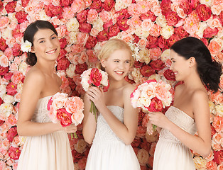 Image showing three women with background full of roses