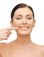 Image showing beautiful woman pointing to teeth