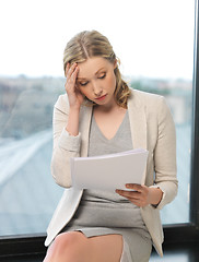 Image showing bored and tired woman with documents