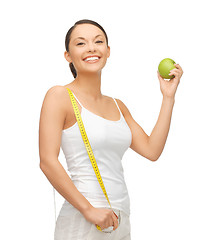 Image showing sporty woman with apple and measuring tape