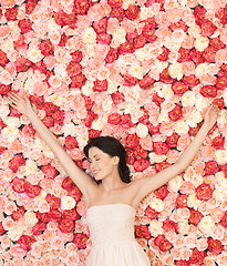 Image showing young woman with background full of roses