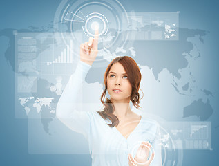 Image showing businesswoman touching virtual screen