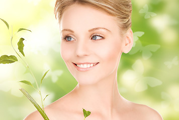 Image showing woman with sprout and butterflies