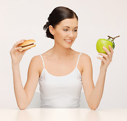 Image showing woman with hamburger and apple