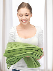 Image showing lovely housewife with towels