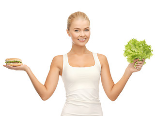 Image showing woman with green lettuce and hamburger