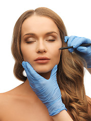 Image showing woman face and beautician hands