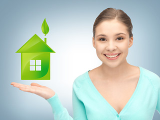 Image showing woman showing light bulb on the palm of her hands