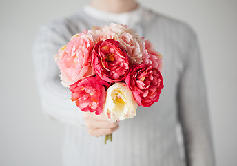 Image showing man giving bouquet of flowers