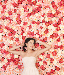 Image showing young woman with background full of roses