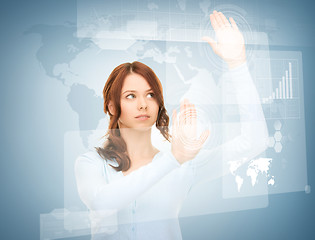 Image showing businesswoman touching virtual screen