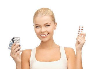 Image showing young woman with pills