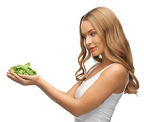 Image showing woman with spinach leaves on palms