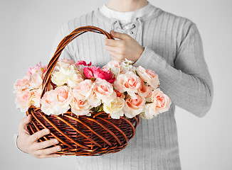 Image showing man holding basket full of flowers