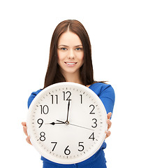 Image showing businesswoman with wall clock