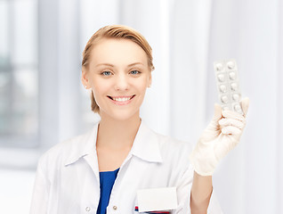 Image showing attractive female doctor with pills