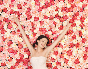 Image showing young woman with background full of roses