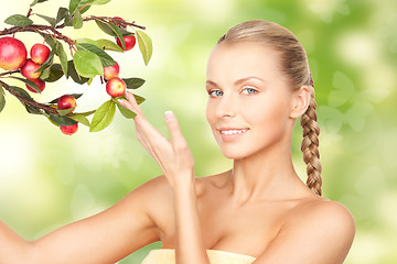 Image showing lovely woman with apple twig and butterflies