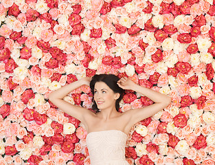 Image showing young woman with background full of roses