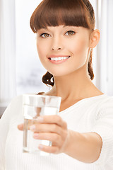 Image showing young smiling woman with glass of water